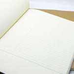 Open notebook showing ivory paper with Cornell layout page