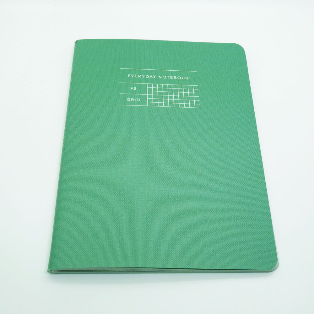Green notebook with title Everyday Notebook A5 Grid