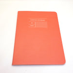 Red notebook with title Everyday Notebook A5 Lined