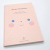 Pale pink notebook with cute face on the front
